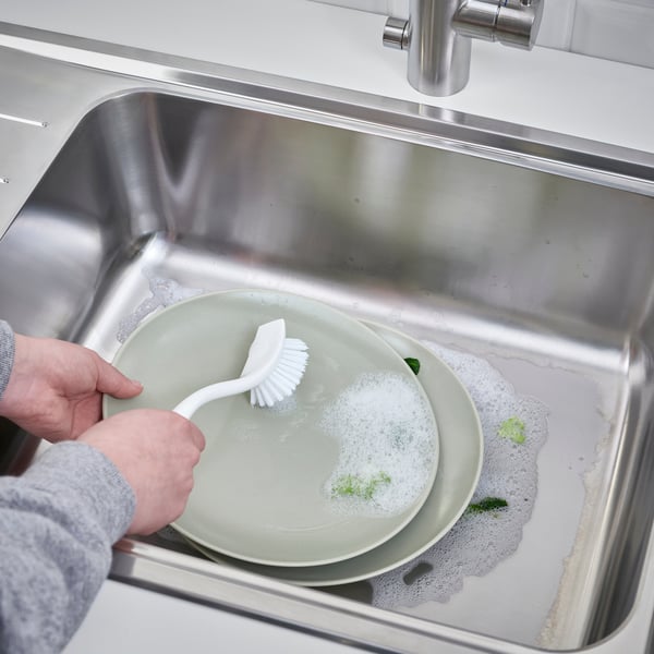A white ANTAGEN dish-washing brush