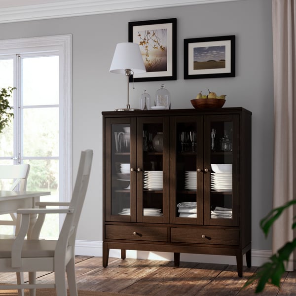 A dark brown stained IDANÄS cabinet with bi-folded glass doors