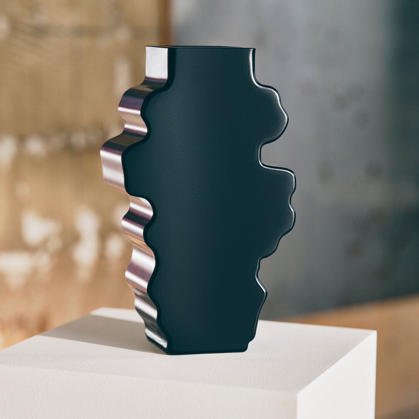 Close up of a black sculpture from the IKEA art collection KONSTRUNDA on a white pedestal in a studio space.