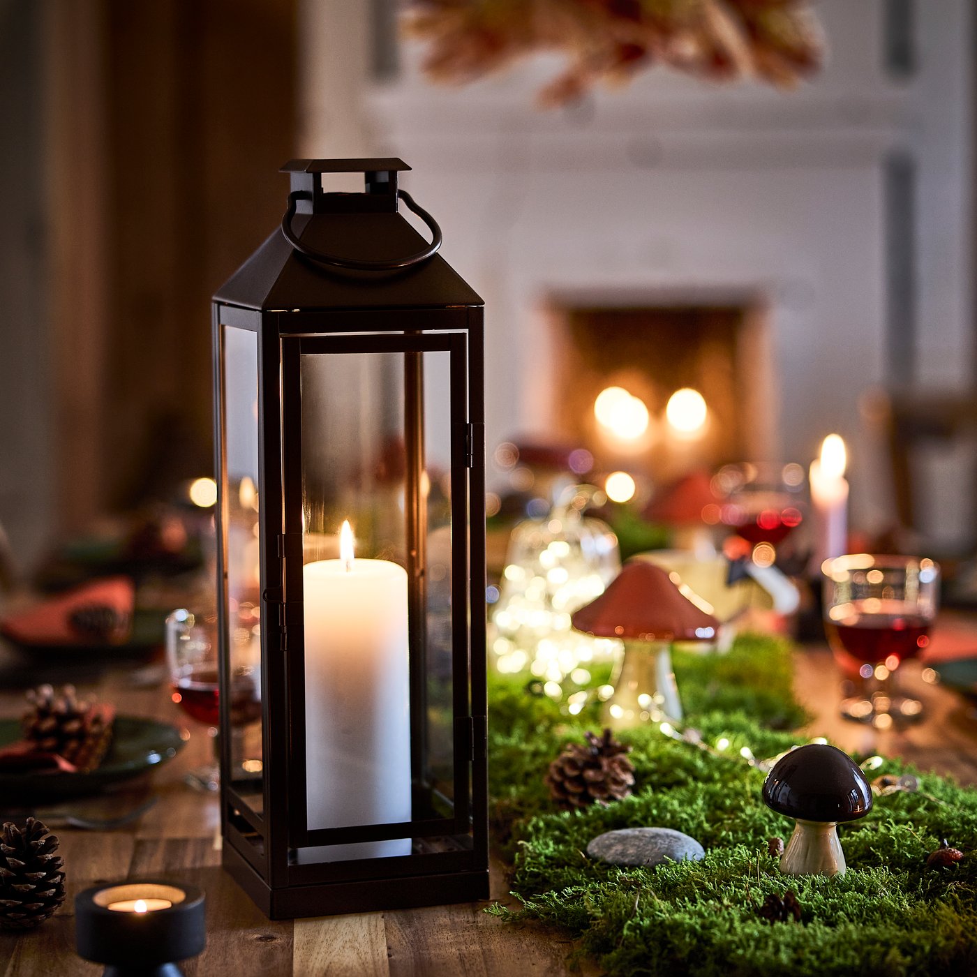 A copper-colour HÖSTAGILLE lantern for pillar candle, in/out in the dining room