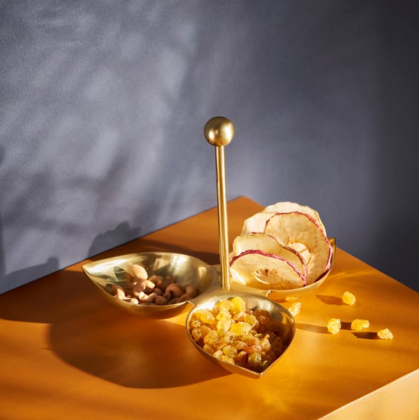 Golden decorative candy dishes in the shape of leaves.