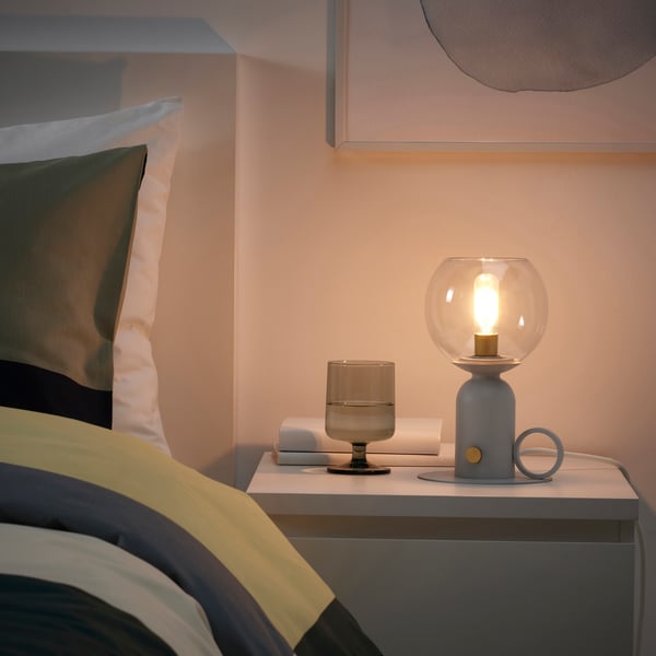 A dimmable light grey ÅSKMULLER table lamp