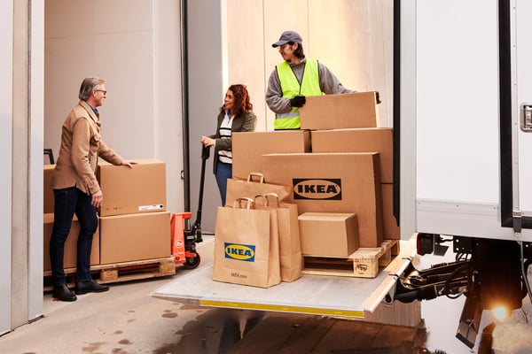 Three people taking care of an IKEA delivery. 