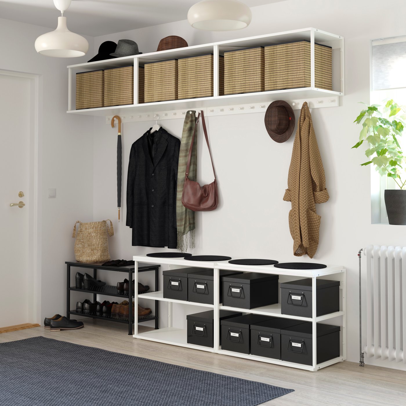 PLATSA system storage units in a main entrance of a home with boxes and shoes neatly organised. 
