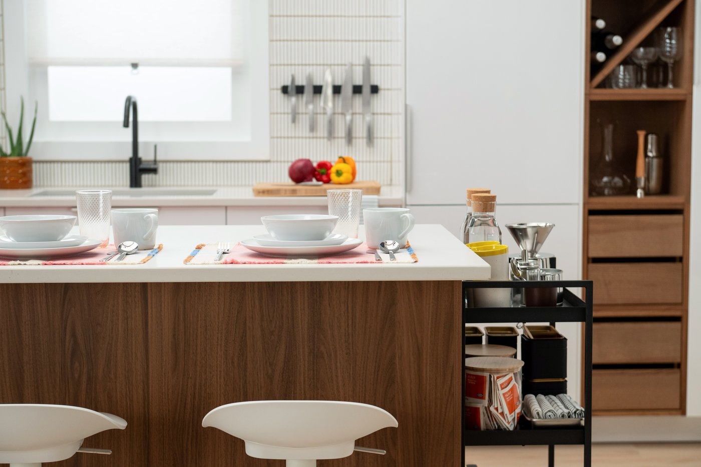 A modern IKEA kitchen with white high-gloss fronts and wood accents 