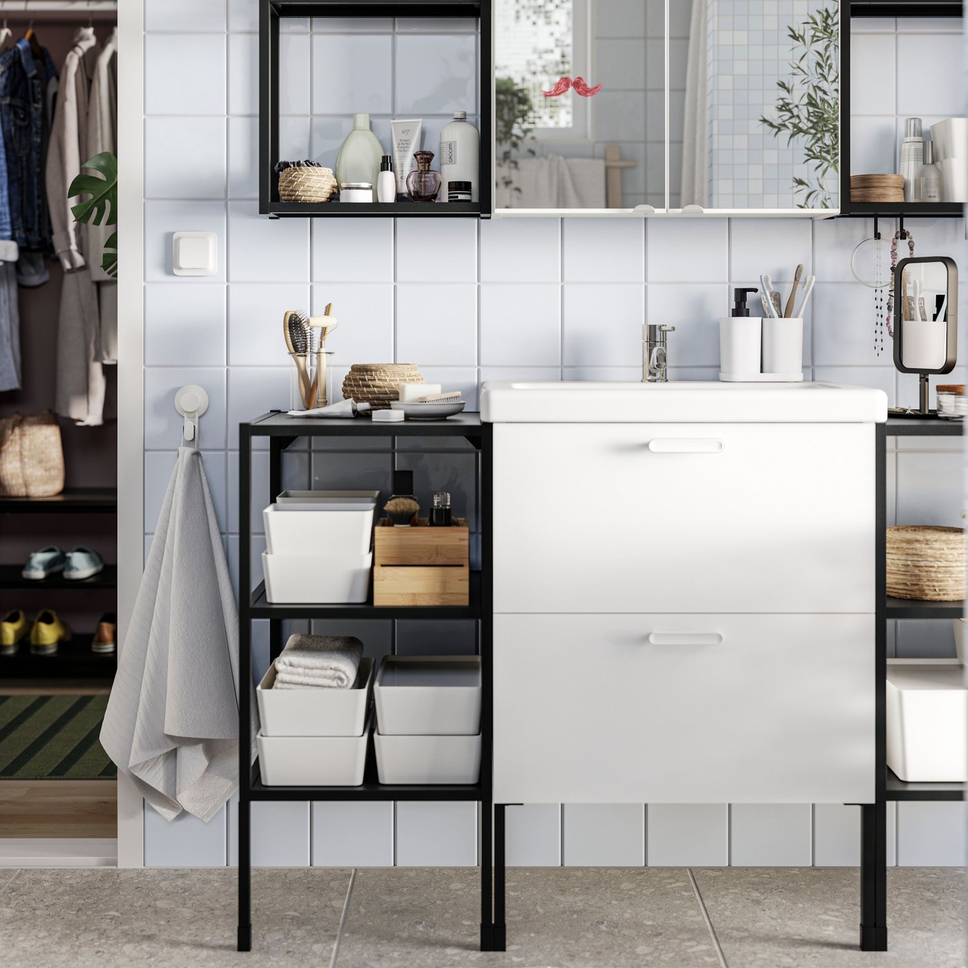 A bathroom has white ENHET base cabinets and ENHET base frames with shelves in anthracite with bathroom items placed on them.
