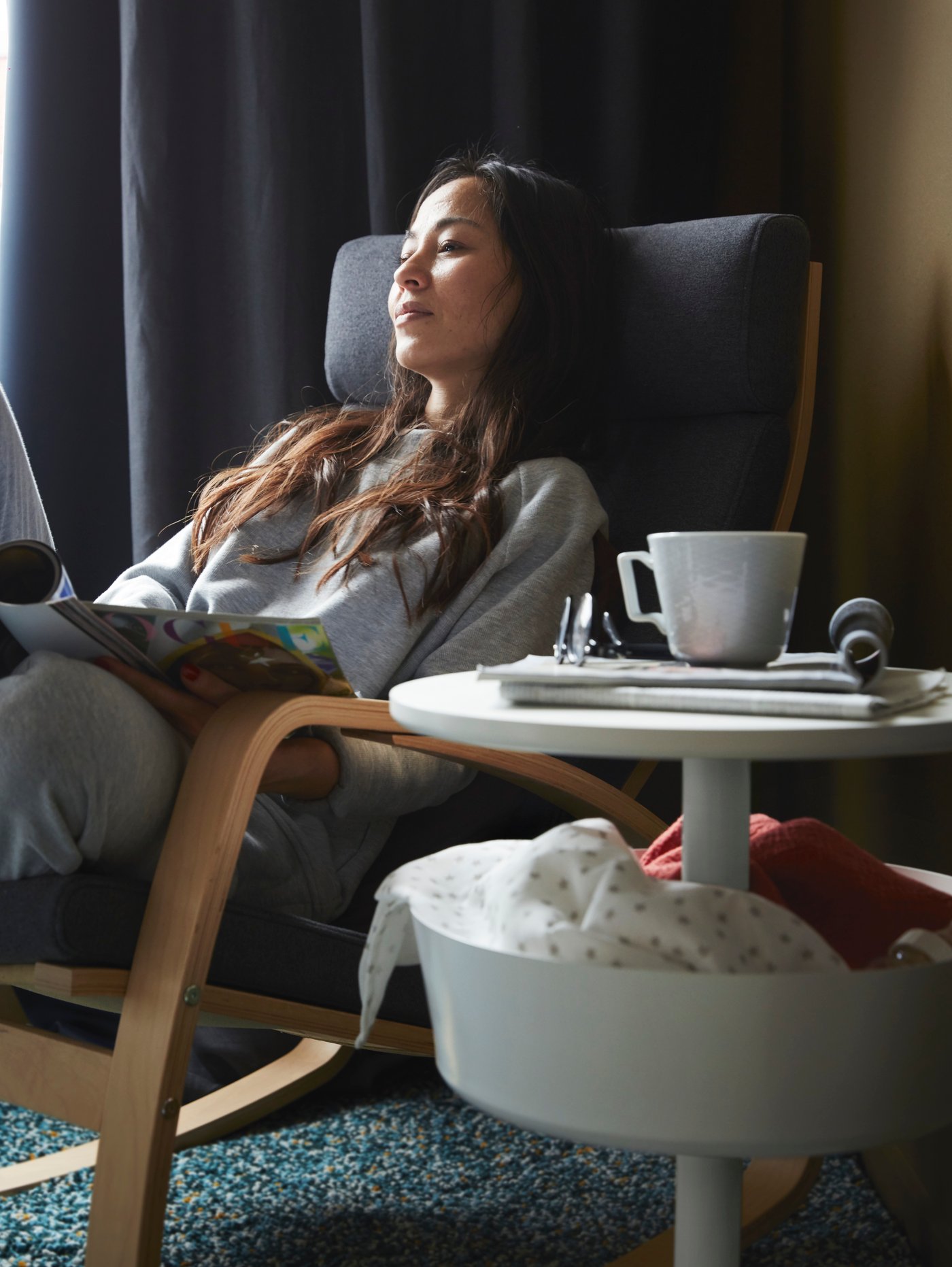 A pair of dark blue MAJGULL blackout curtains in the living room.