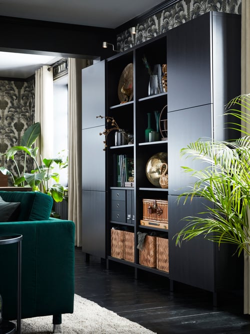 A black-brown BESTÅ storage combination with two columns of closed storage and two of open storage holding baskets and boxes.