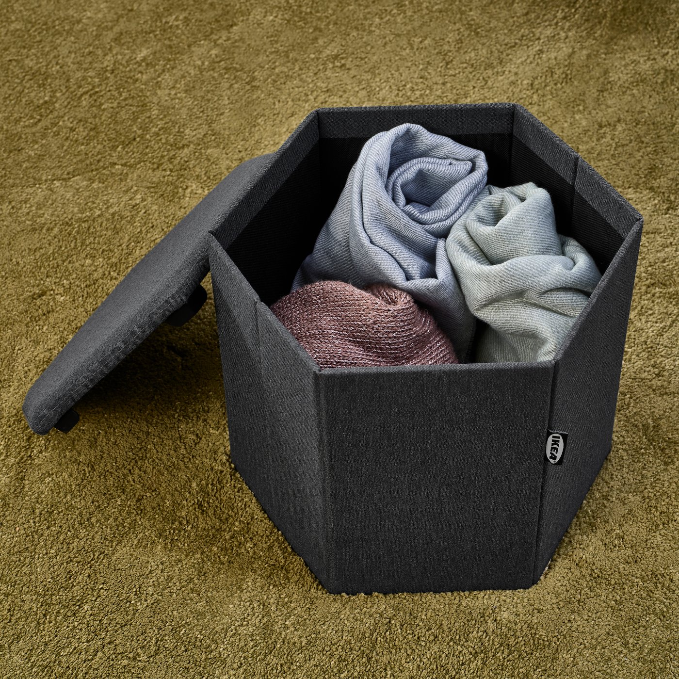 A Knisa dark grey KJUGE pouffe with storage