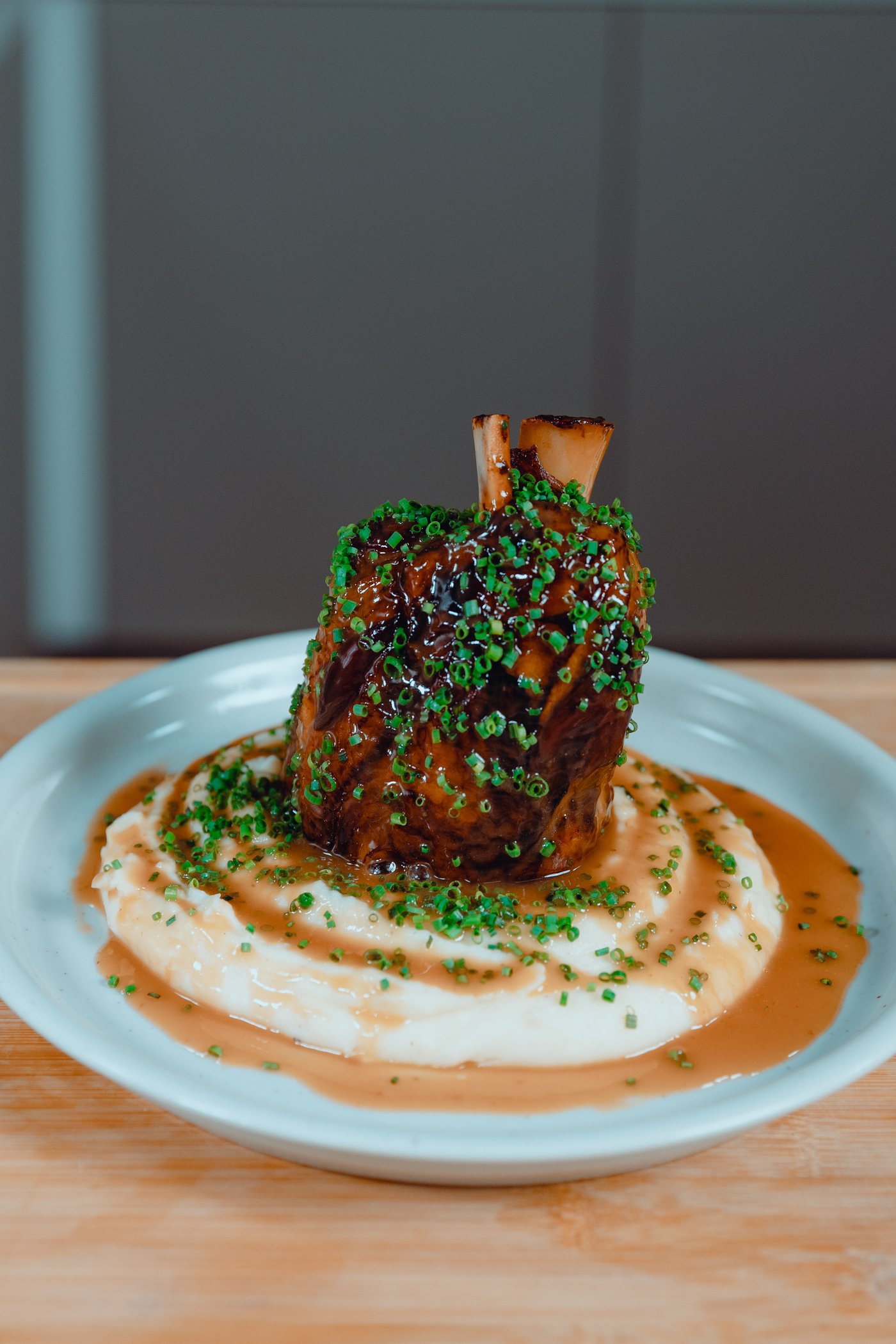 Chef Carlos Afonso preparing pork knuckle with mashed potatoes