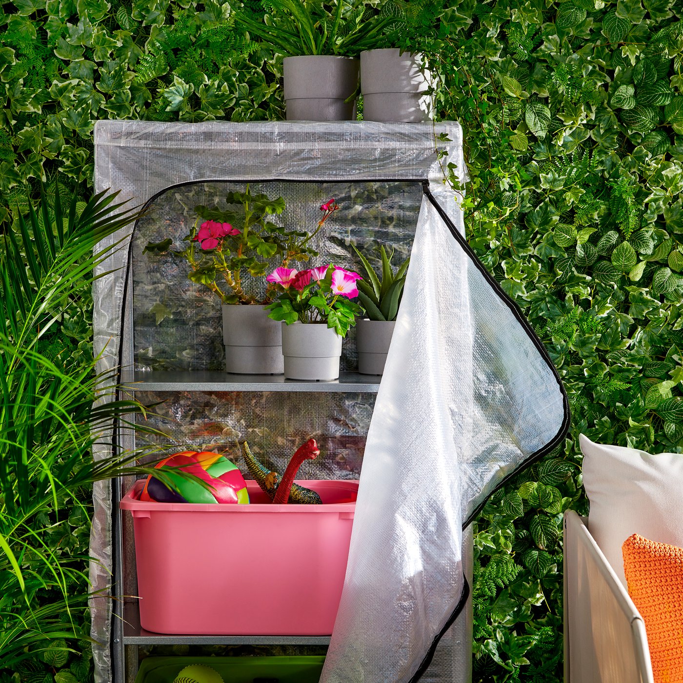 A transparent HYLLIS shelving unit with cover