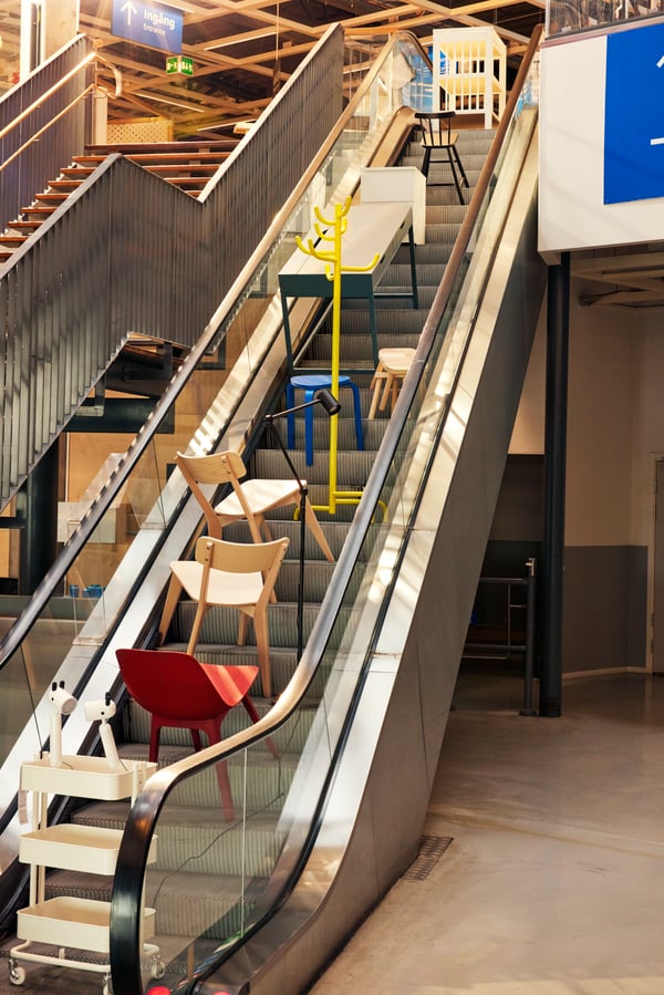 Ikonické výrobky IKEA na eskalátoru v obchodním domě. 