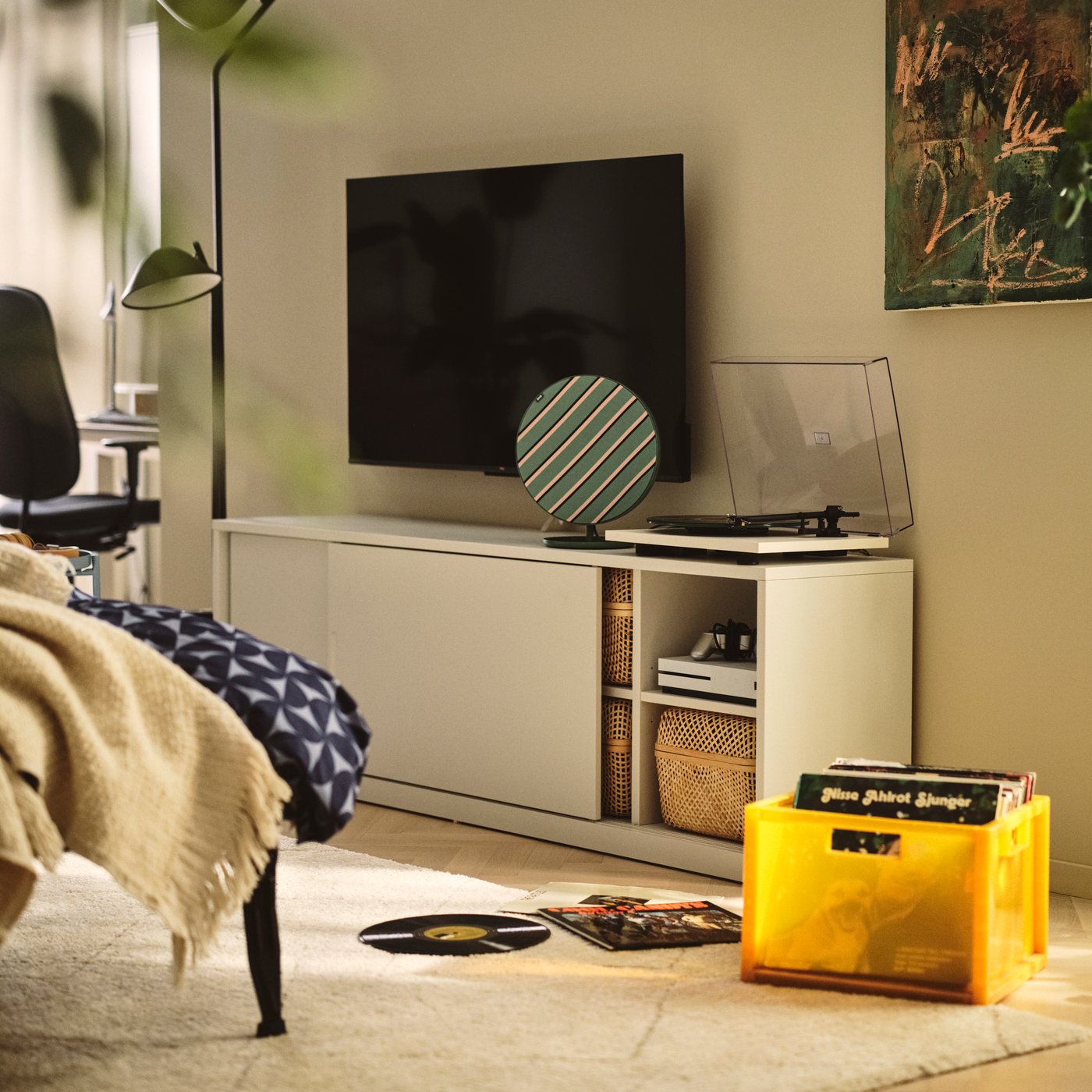 A living room with an off-white TONSTAD sideboard with open compartments showing storage boxes inside.