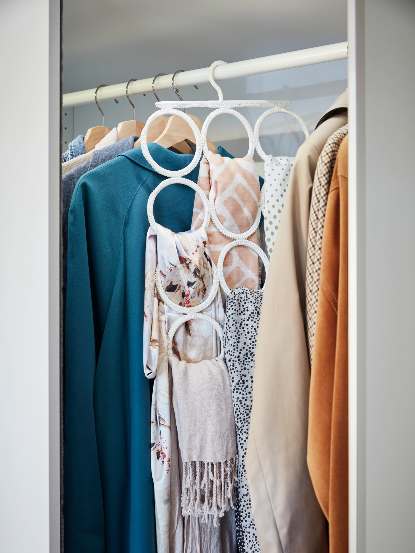 A white KOMPLEMENT multi-use hanger in the bedroom