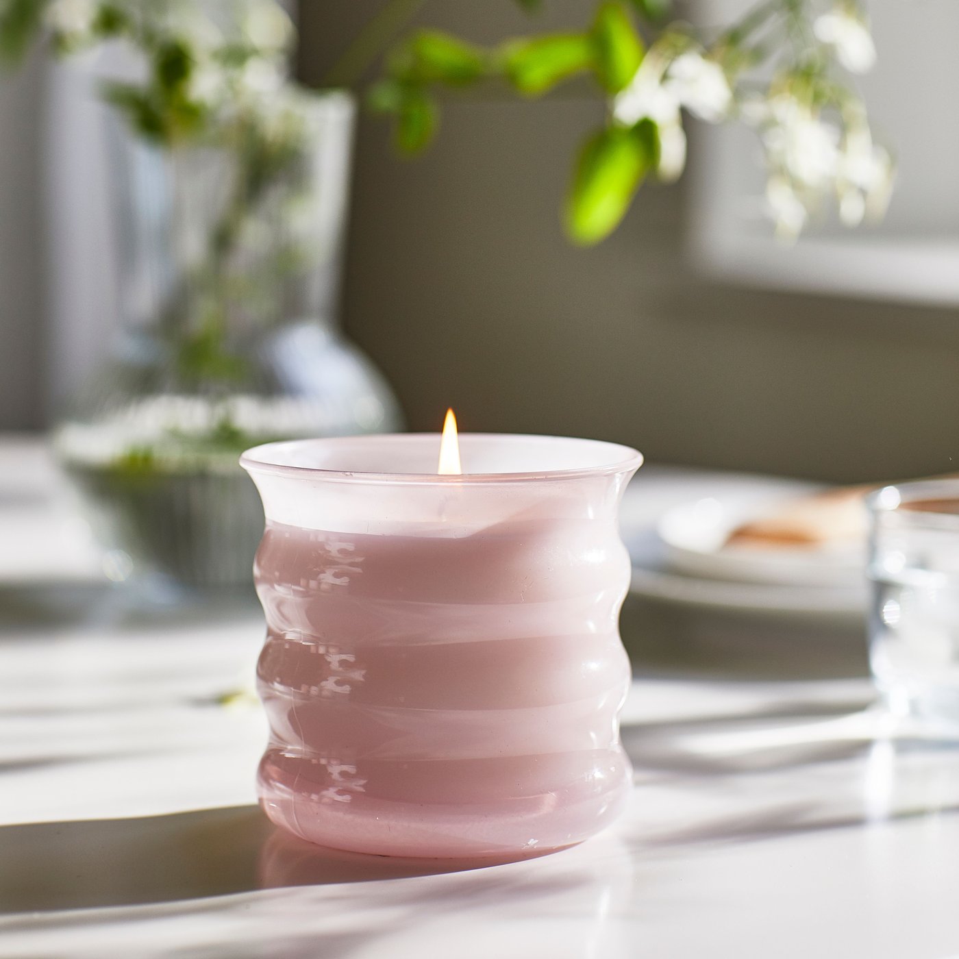 Różowa świeca zapachowa LUGNARE w szklanym słoiku.