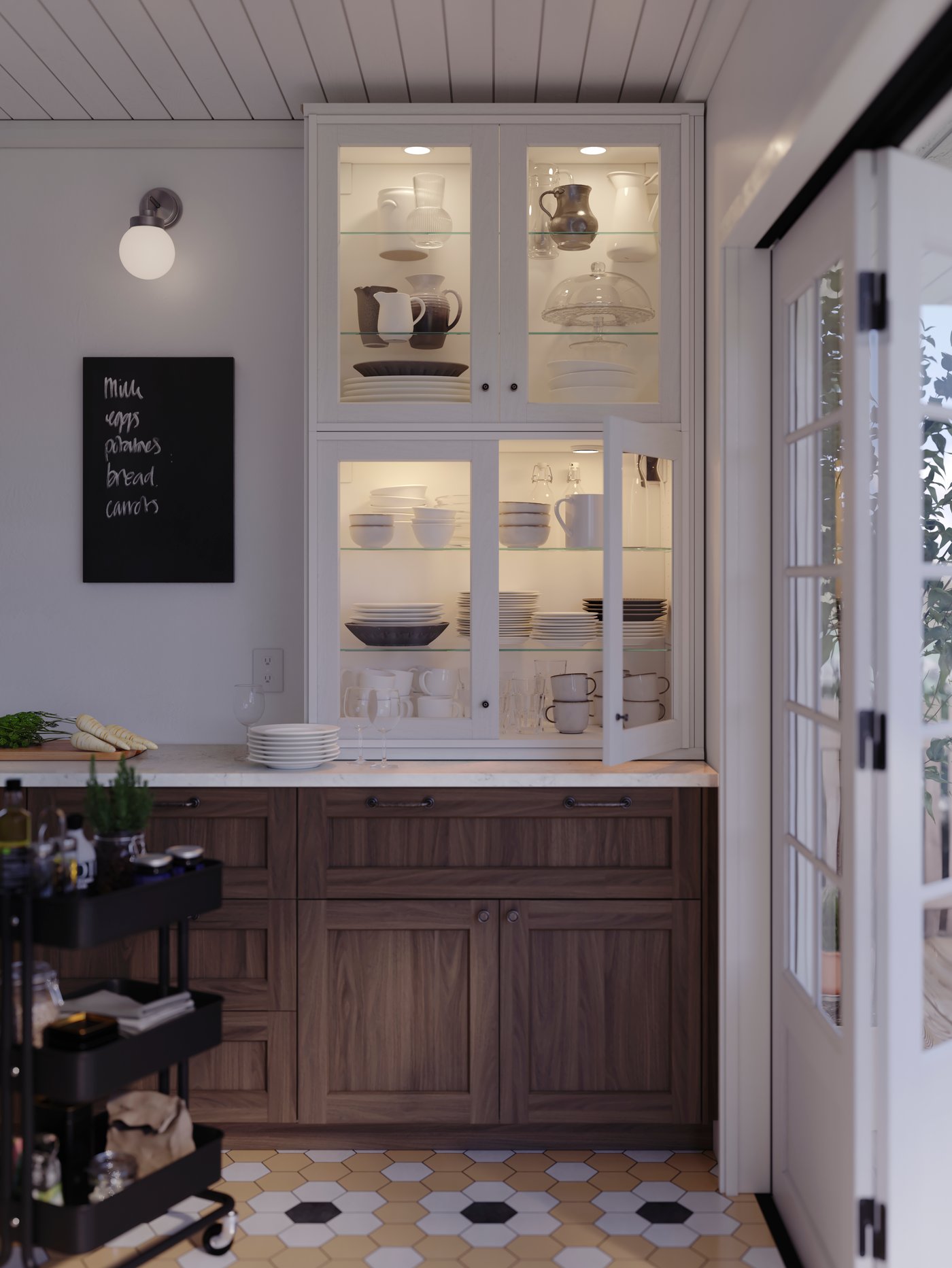 Two SEKTION cabinets with white ENKÖPING glass doors on top of a kitchen countertop filled with dinner- and serveware.