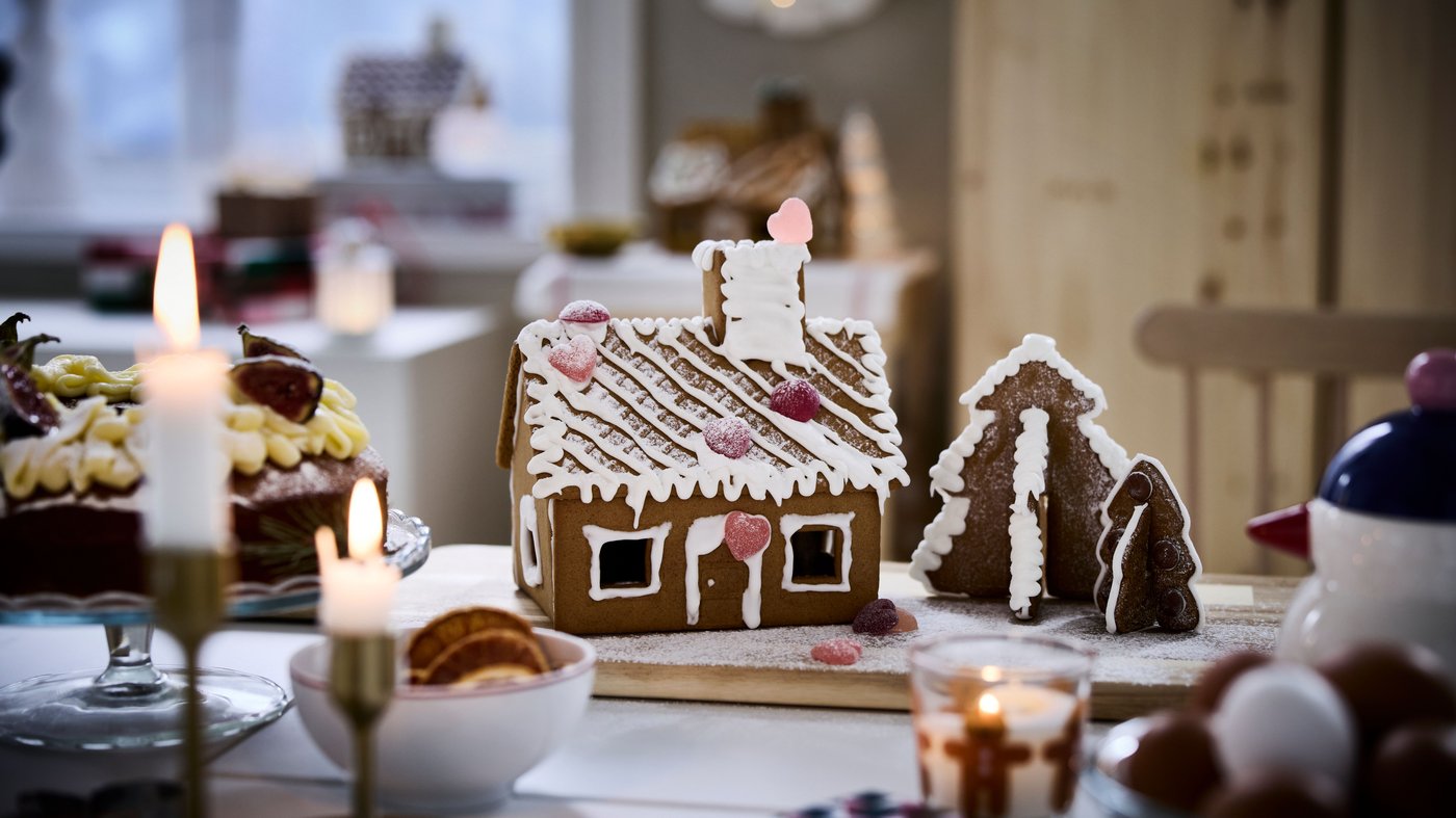 A fully decorated gingerbread house on a kitchen table