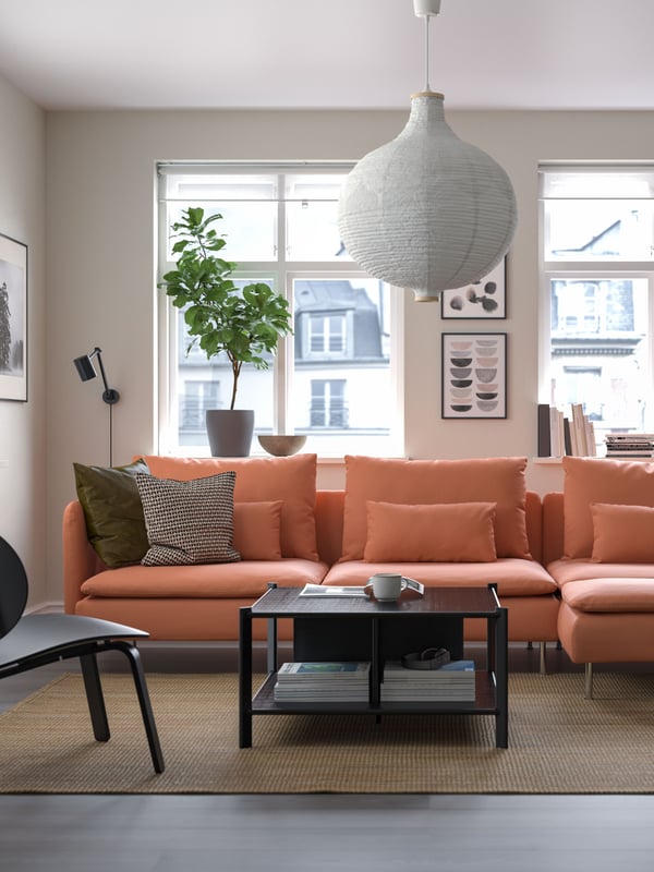 A brown orange SÖDERHAMN sofa with a cover in the living room.