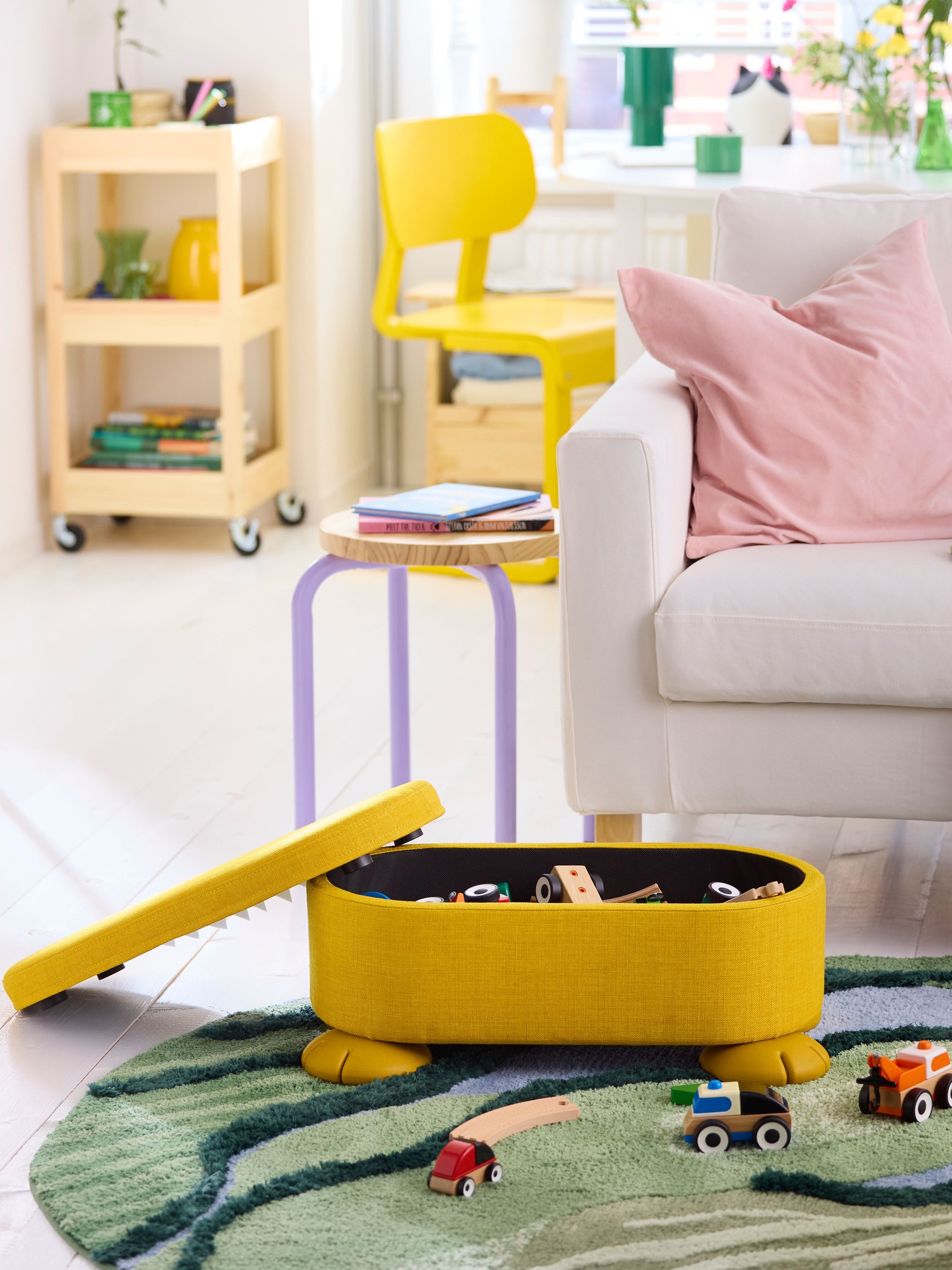 An yellow GREJSIMOJS pouffe with storage in the NA