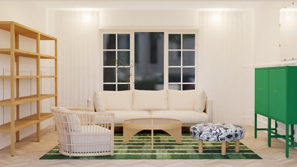 A bright living room with a light-colored sofa, wooden bookshelves, a green storage cabinet, a patterned green rug, and a woven armchair, shown in a simple and undecorated setup.