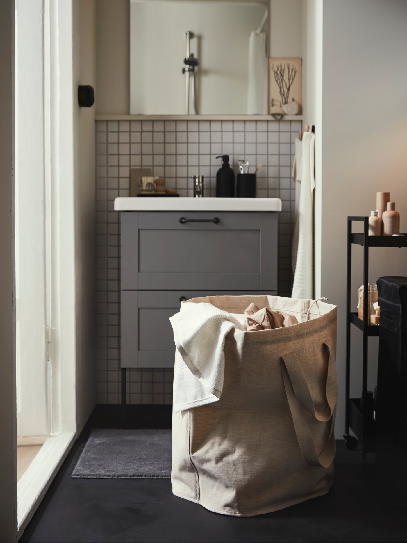 A beige PURRPINGLA laundry bag