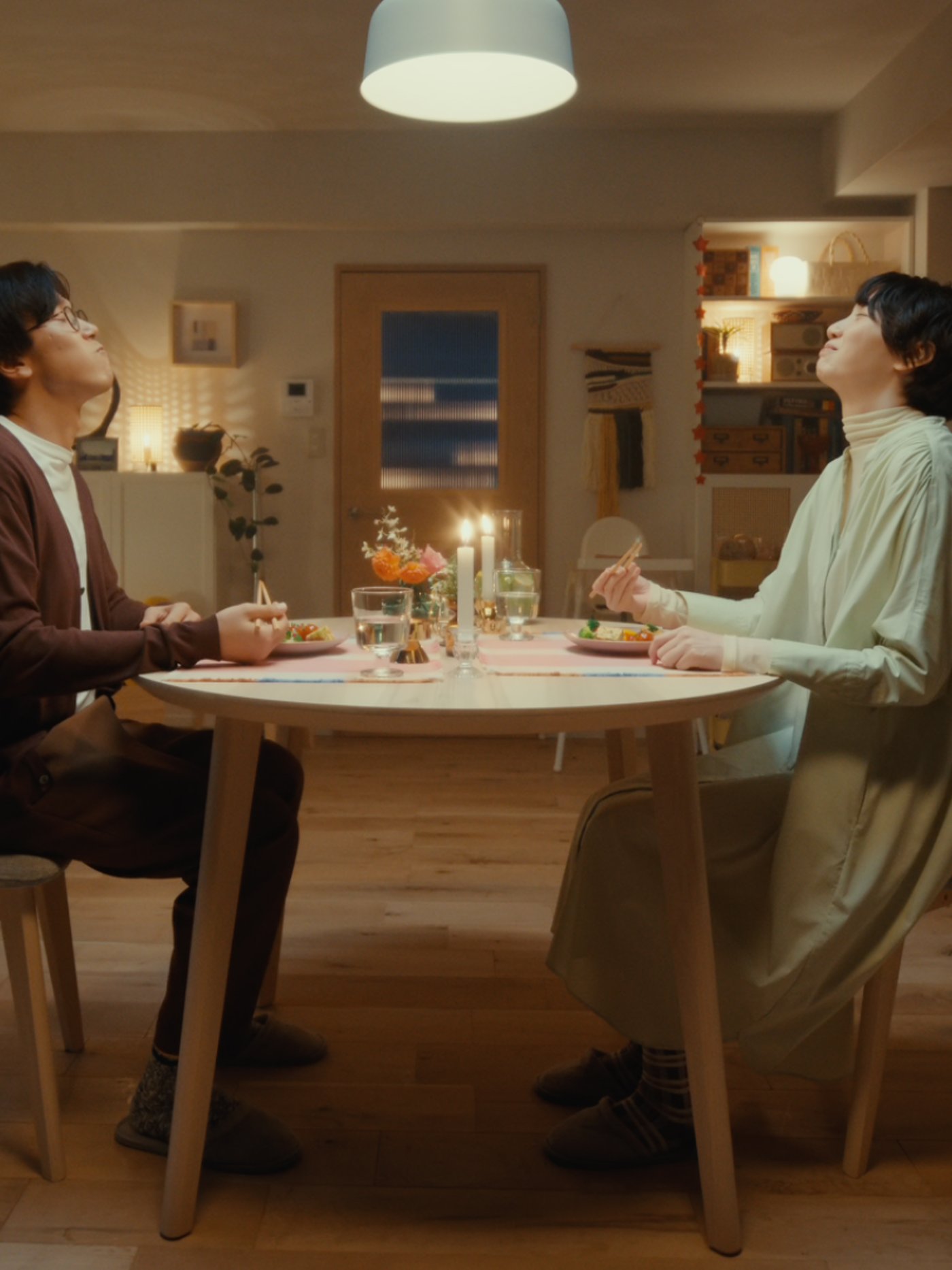 Dining scene with colorful vegetable dishes on a candlelit table