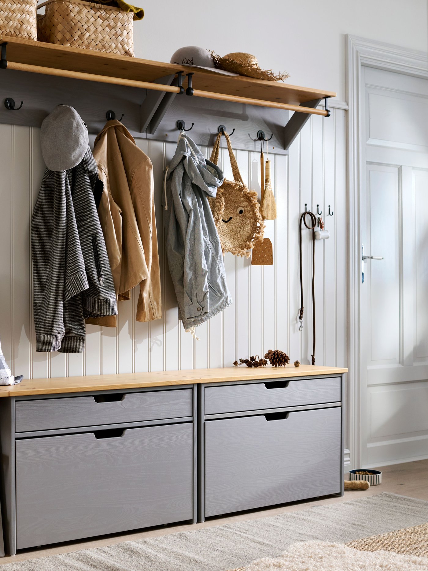 A bamboo/handmade VÄXTHUS basket in the hallway
