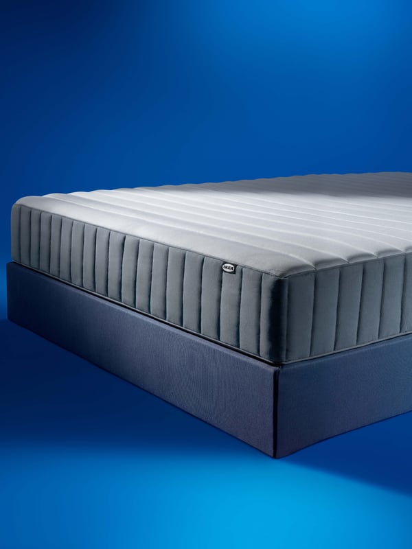 A firm/light blue VALEVÅG pocket sprung mattress