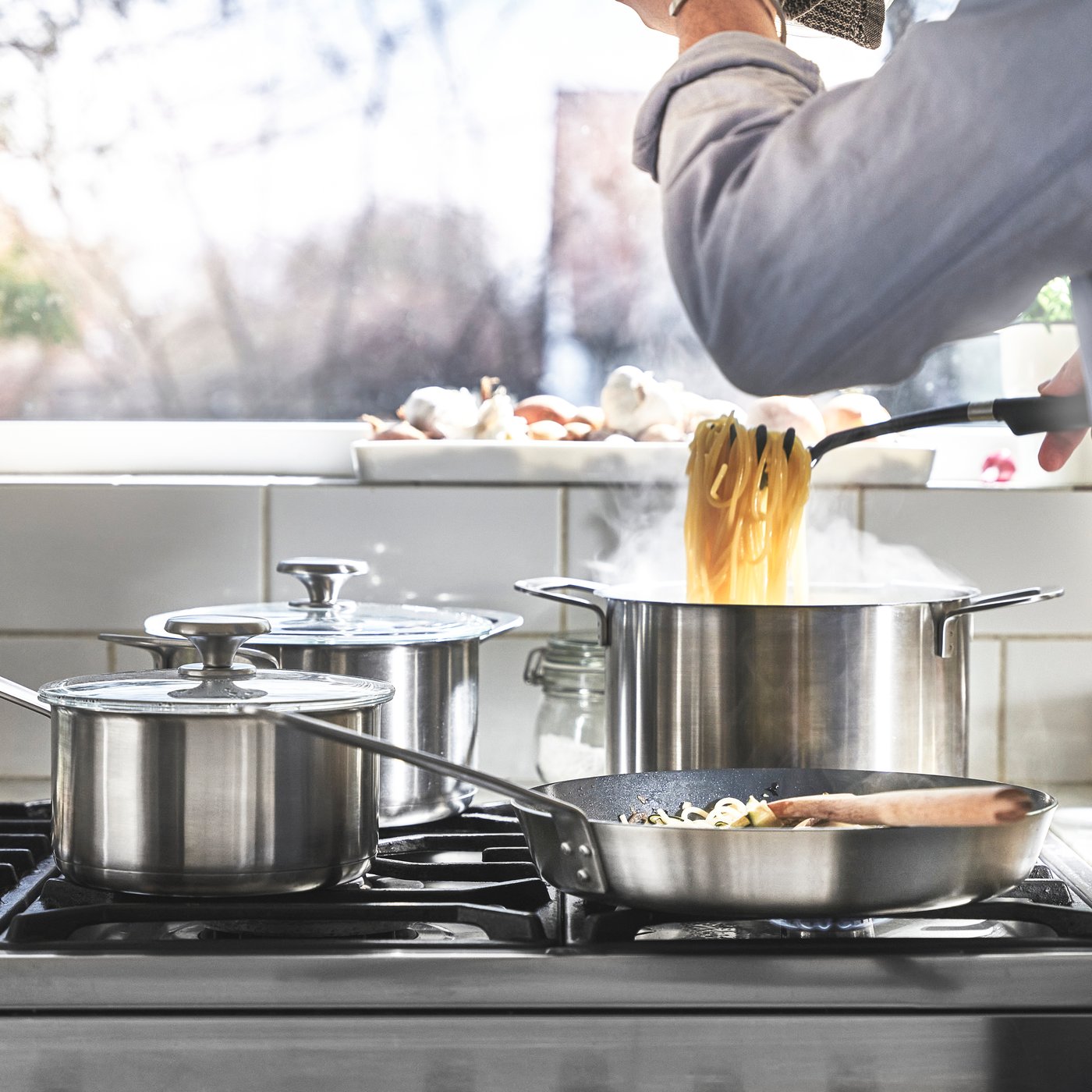 A stainless steel HEMKOMST 7-piece cookware set