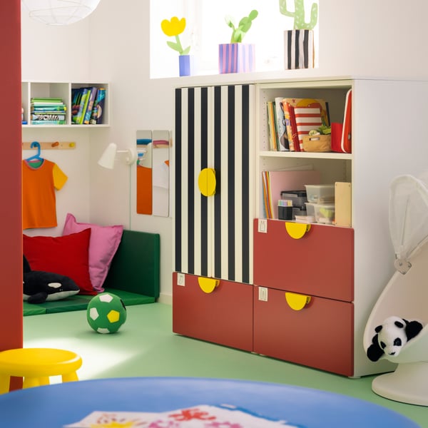 SMÅSTAD storage combination, with red drawers, a black and white striped door and yellow handles.