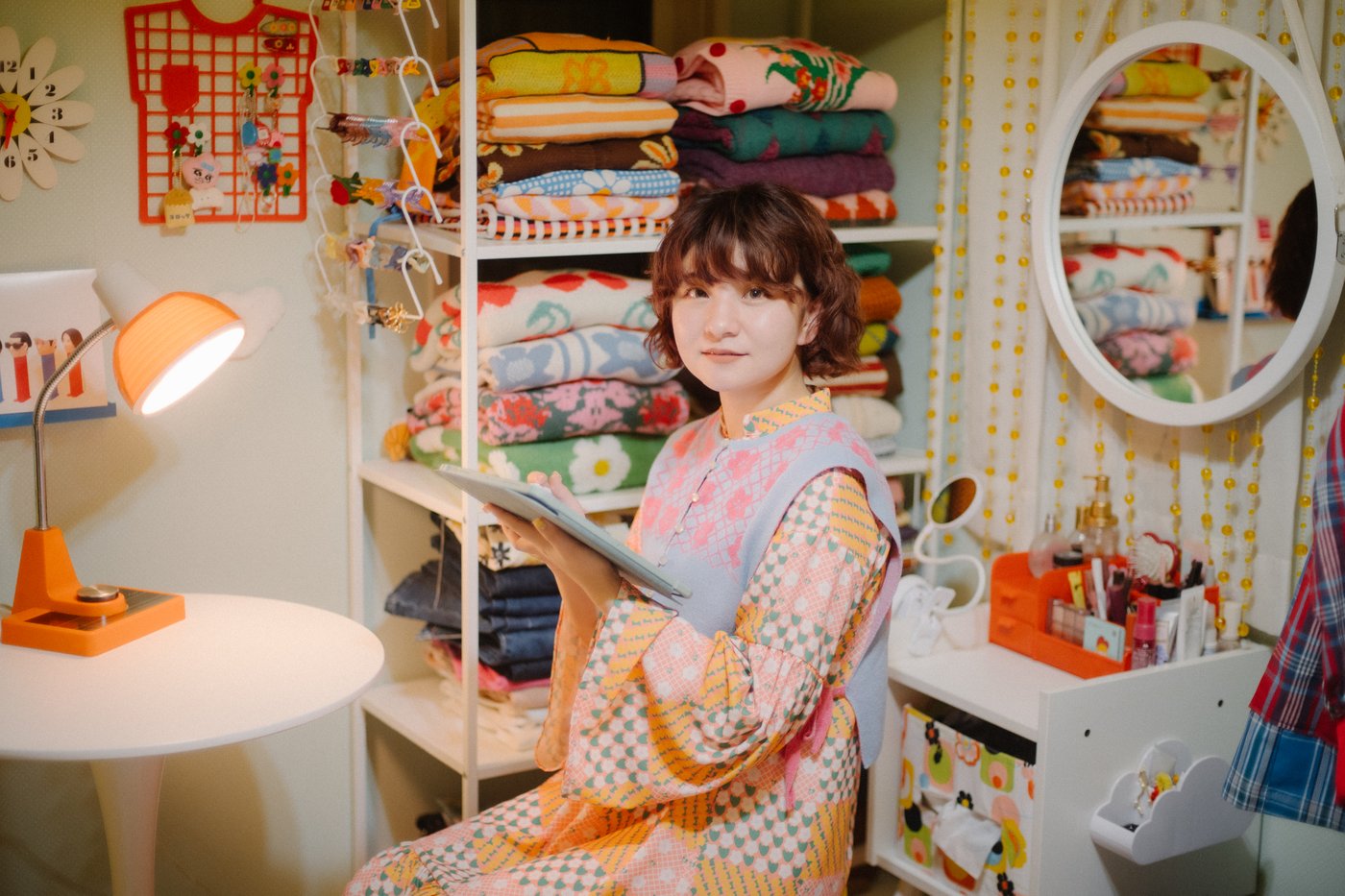 Machiko Naito sitting on a desk in her room