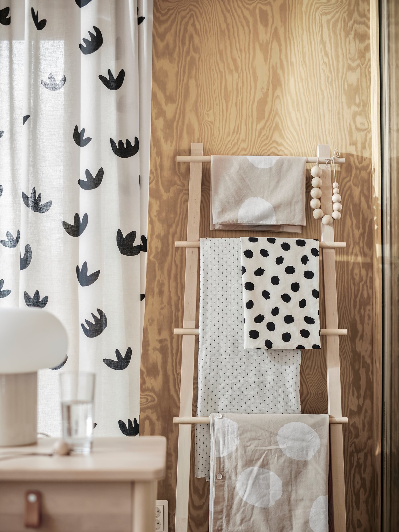 A beige/black NÄCKROSMOTT curtains, 1 pair