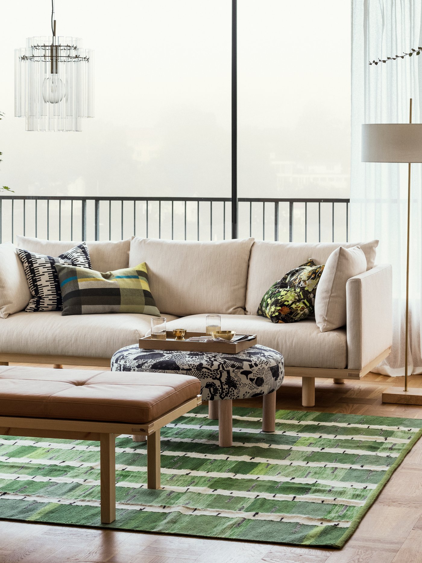 An off-white/black STOCKHOLM 2025 cushion cover in the living room