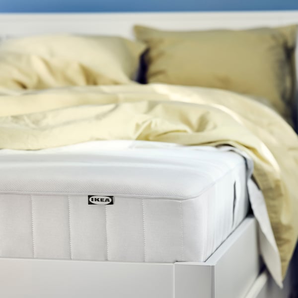 A VESTERÖY mattress on a bed.