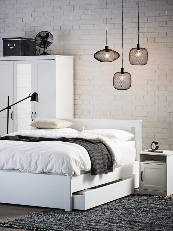 A black SKURUP floor/reading lamp in the bedroom
