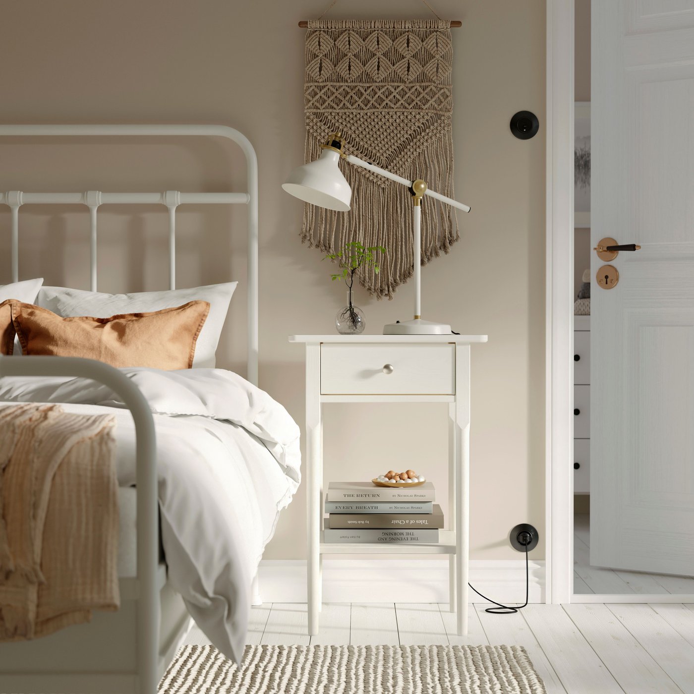 A white BLÄSTÅSEN bedside table in the bedroom