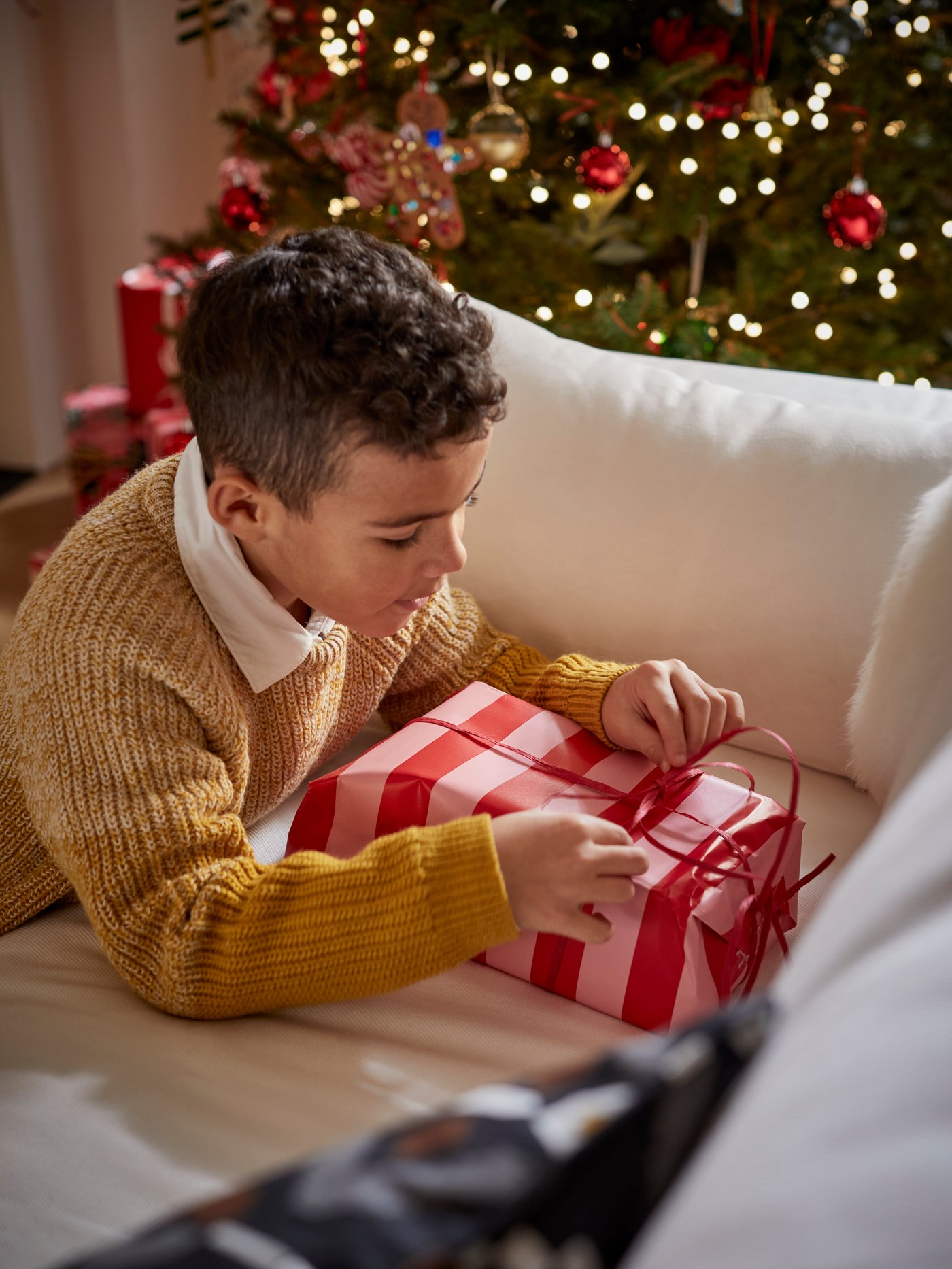 A black/light grey MOSSNYCKLAR cushion cover in the living room