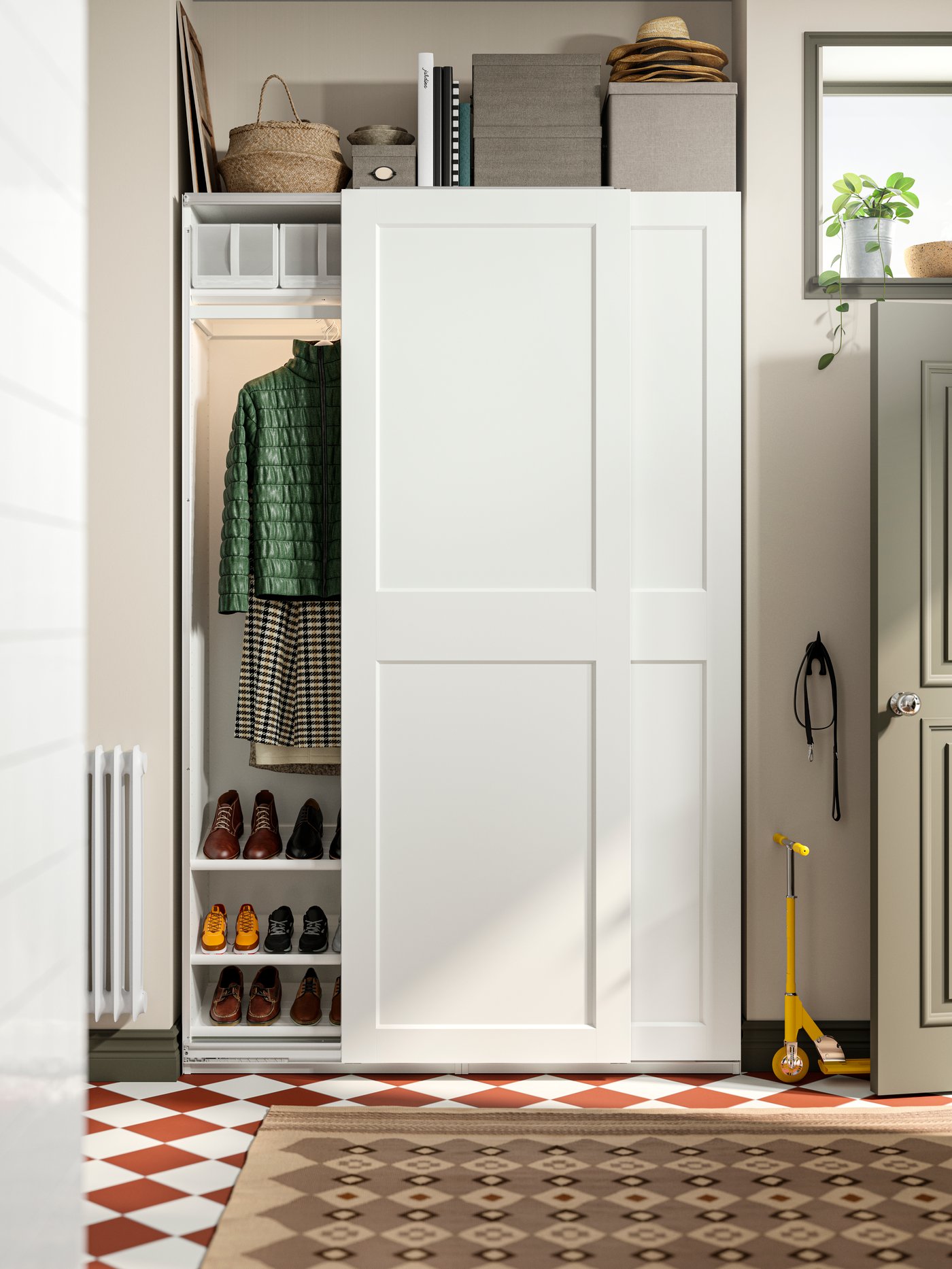 A white PAX wardrobe with sliding doors, in the corner of the hallway. Baskets and boxes on top of it, one door open.
