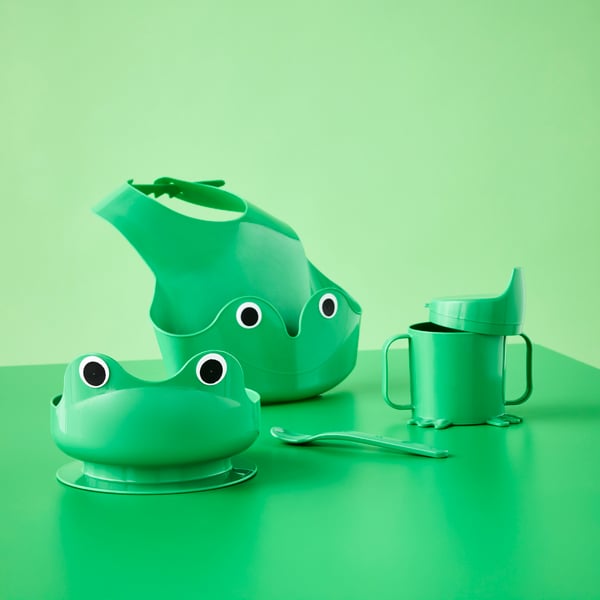 Bright green frog-themed four-piece MATA baby tableware set with bib, bowl, sippy cup and spoon.