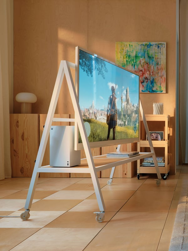A white YXSTABY gaming tv stand on castors in the living room