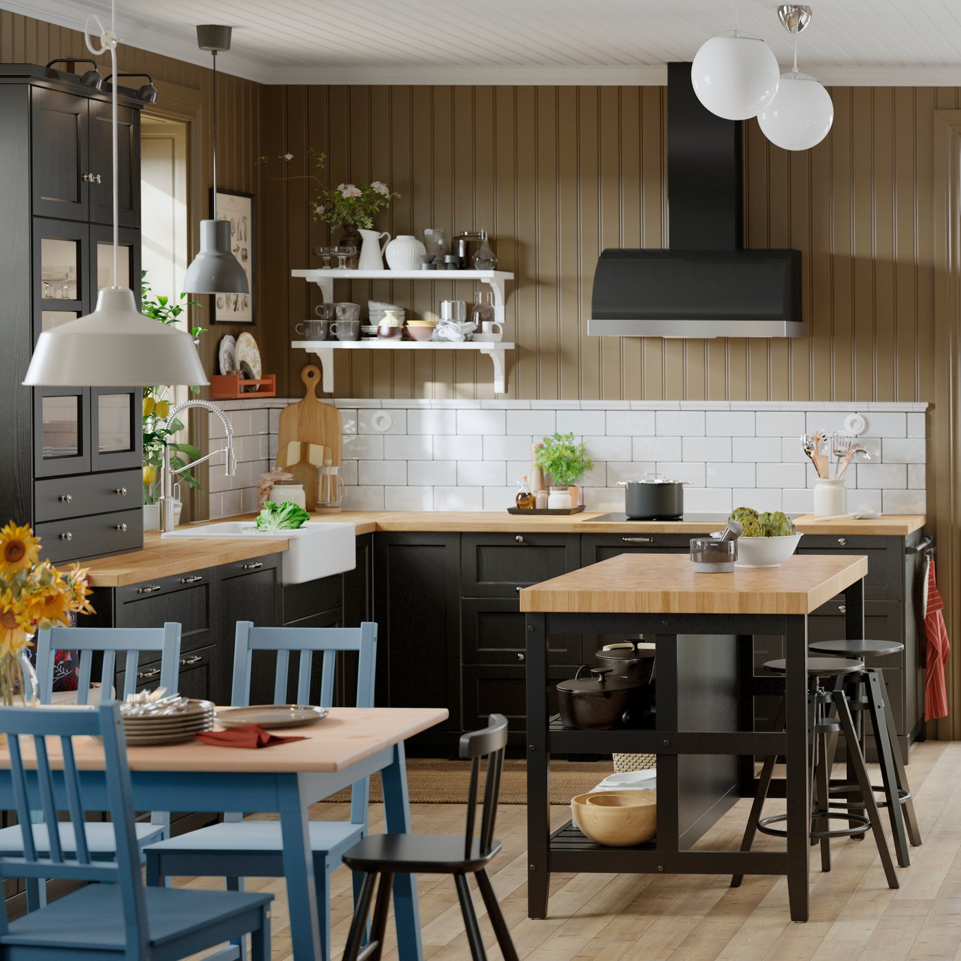 A kitchen with SEKTION cabinets featuring a white HAVSEN sink bowl and VADHOLMA kitchen island with a wooden countertop.