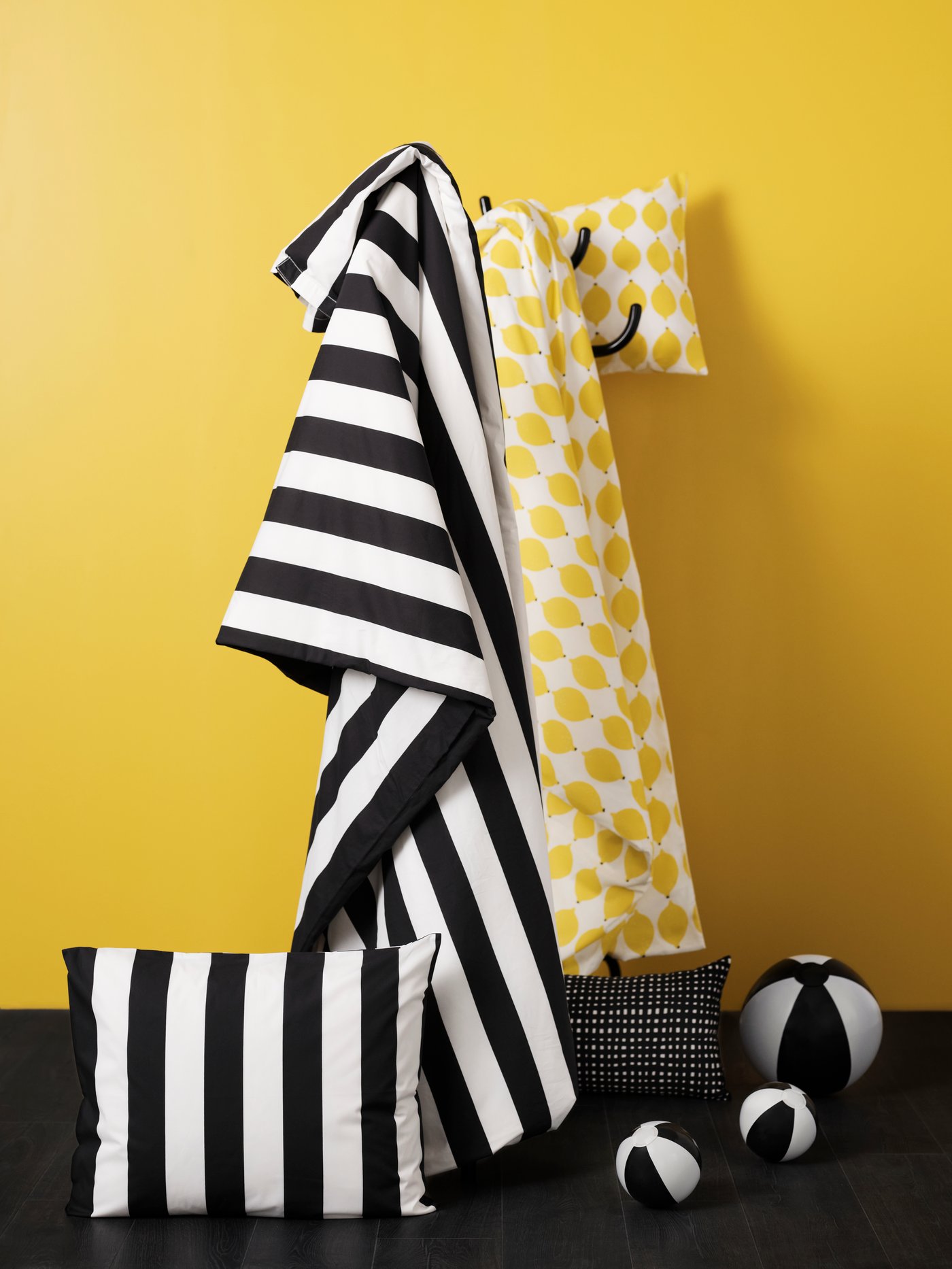 A black/white/striped SLÅNHÖSTMAL duvet cover and pillowcase