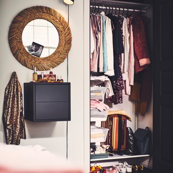 An open wardrobe in a small bedroom