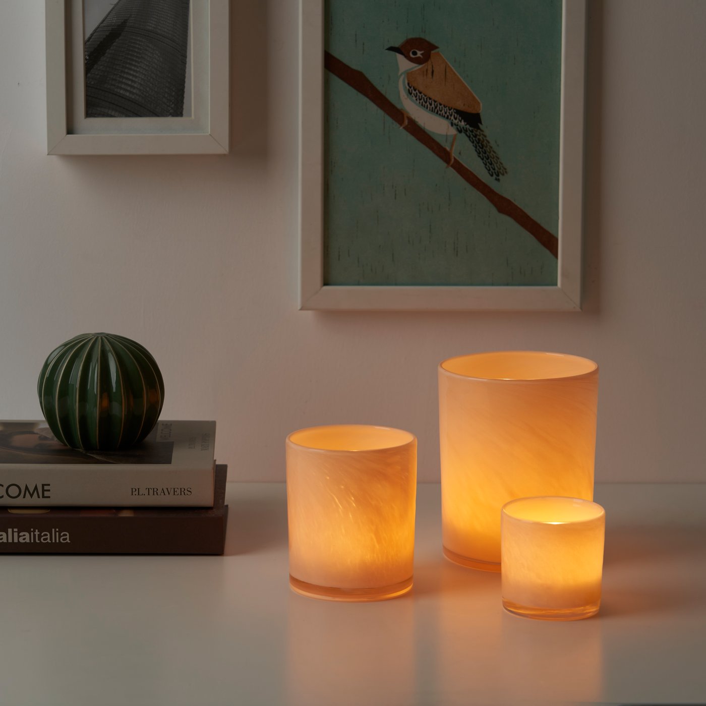 VINDSTILLA candle holder, orange, multiple sizes on a table