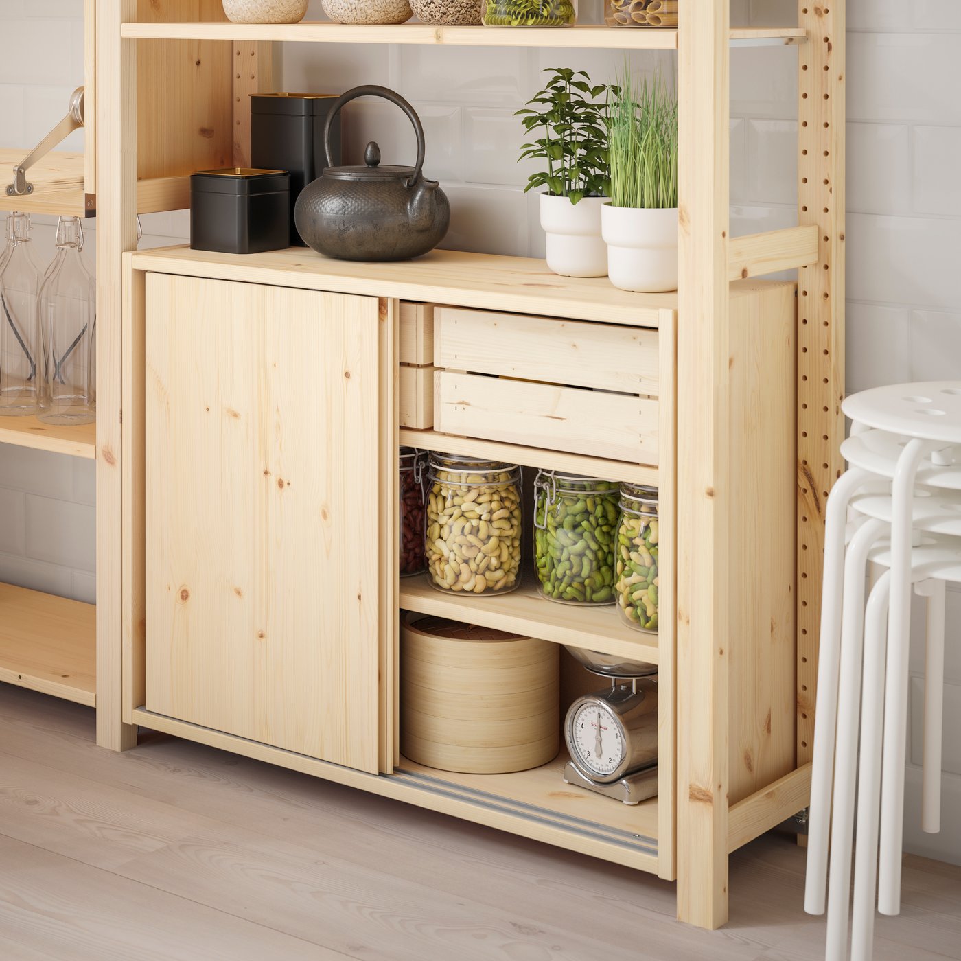A pine IVAR cabinet with sliding doors