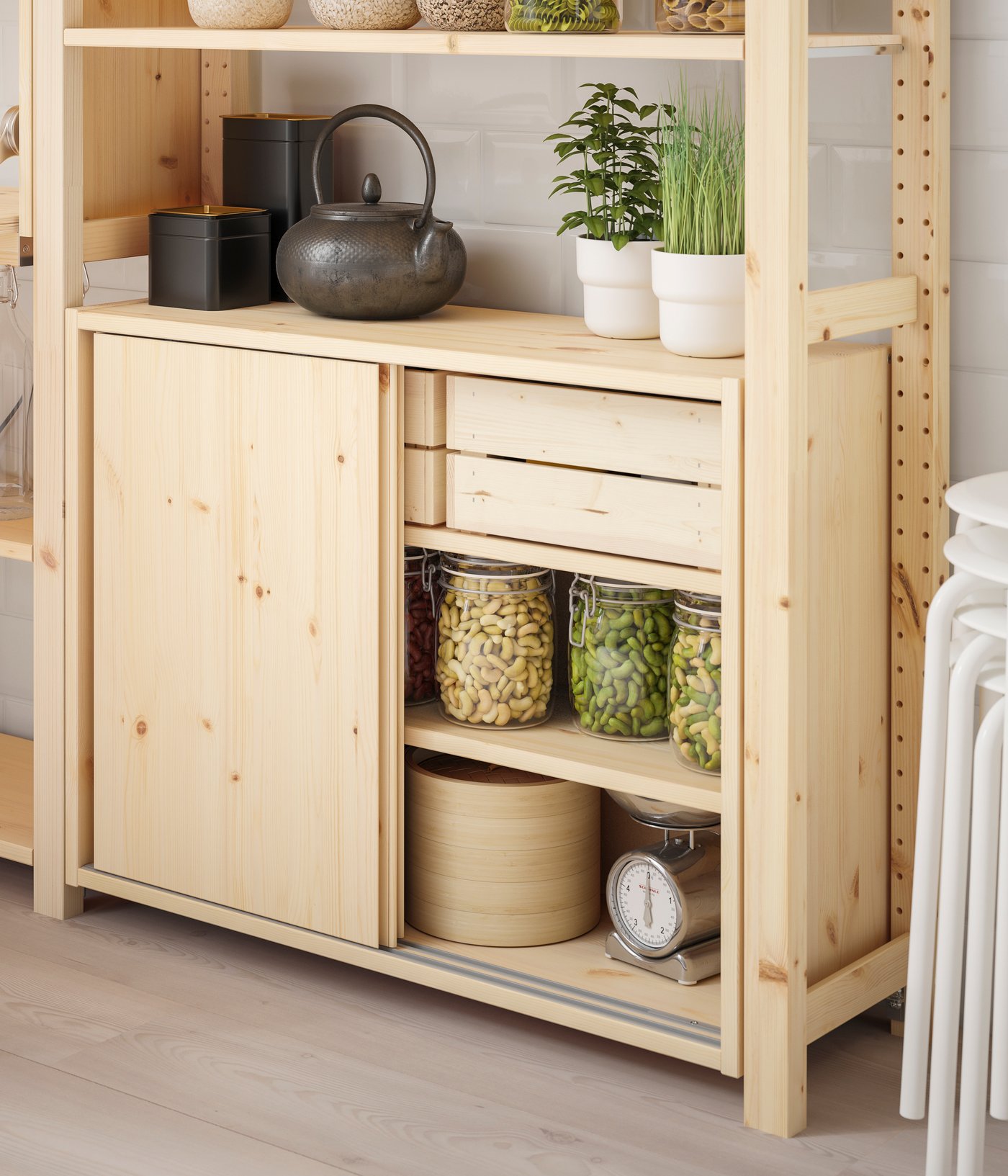A pine IVAR cabinet with sliding doors