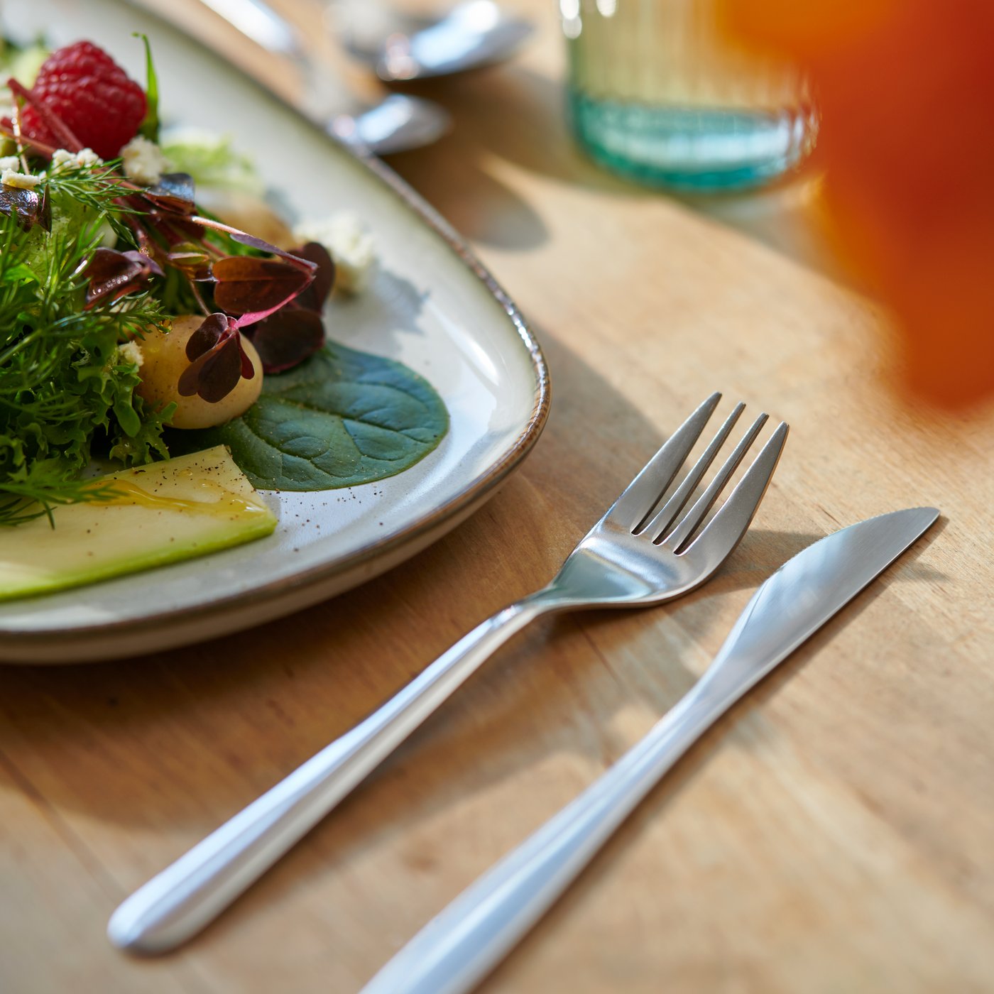 An IKEA FÖRNUFT fork and knife on a wooden table.