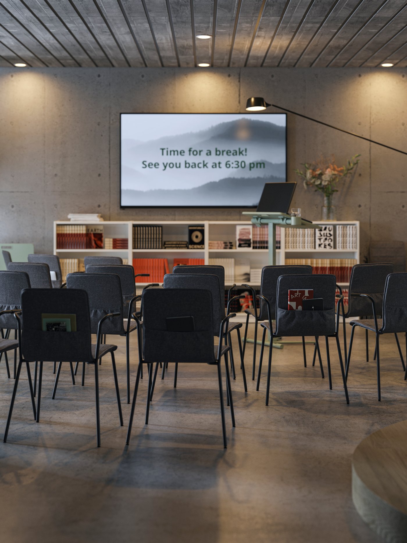 A modern space, with dark grey concrete walls and floors. LÄKTARE conference chairs are placed facing a large screen.