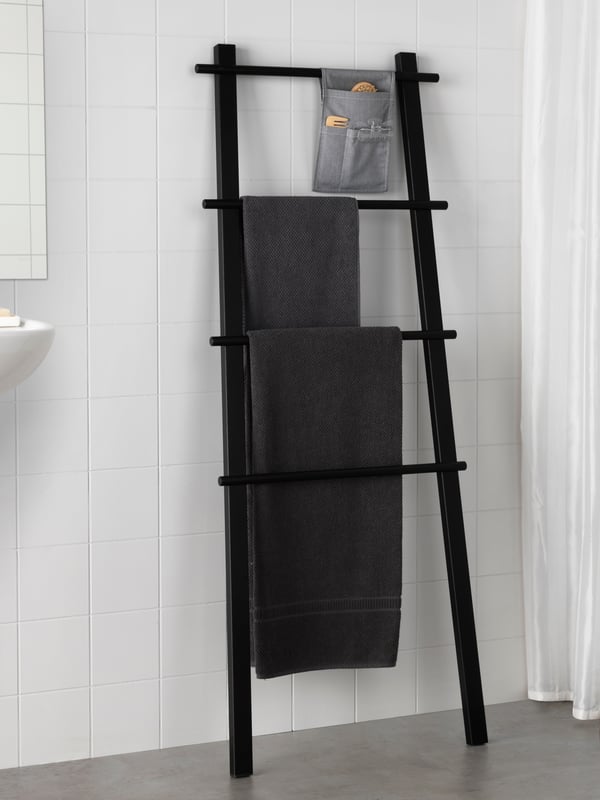 A black VILTO towel stand in the bathroom