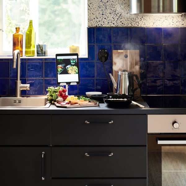 An IKEA kitchen with a boiling pot on the electric stove.